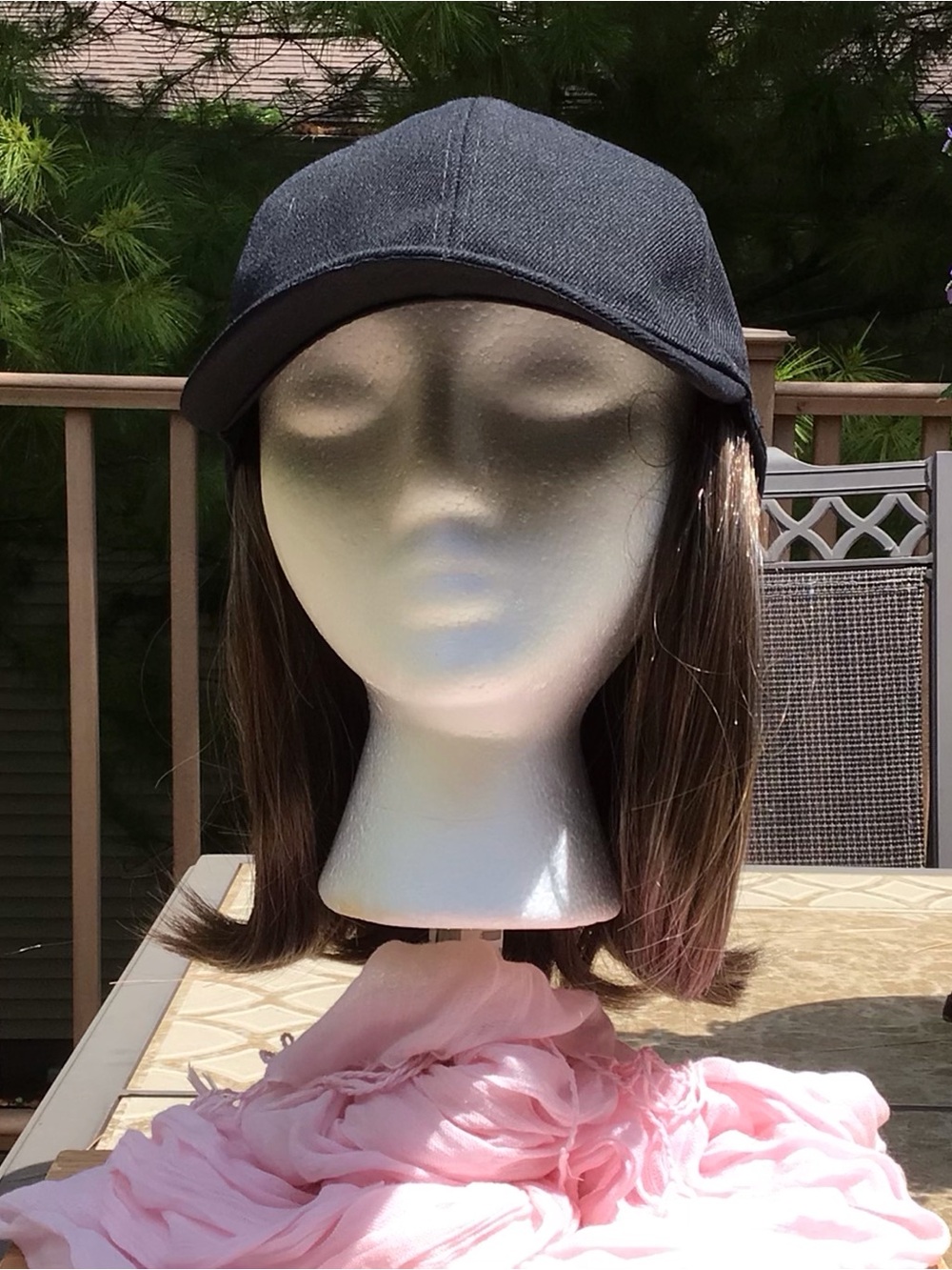 Black baseball cap with brown/blonde highlights attached wig